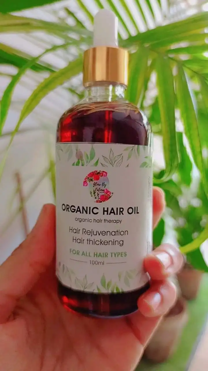 Organic hair oil bottle made with natural ingredients for hair growth, scalp nourishment, and reduced hair fall.